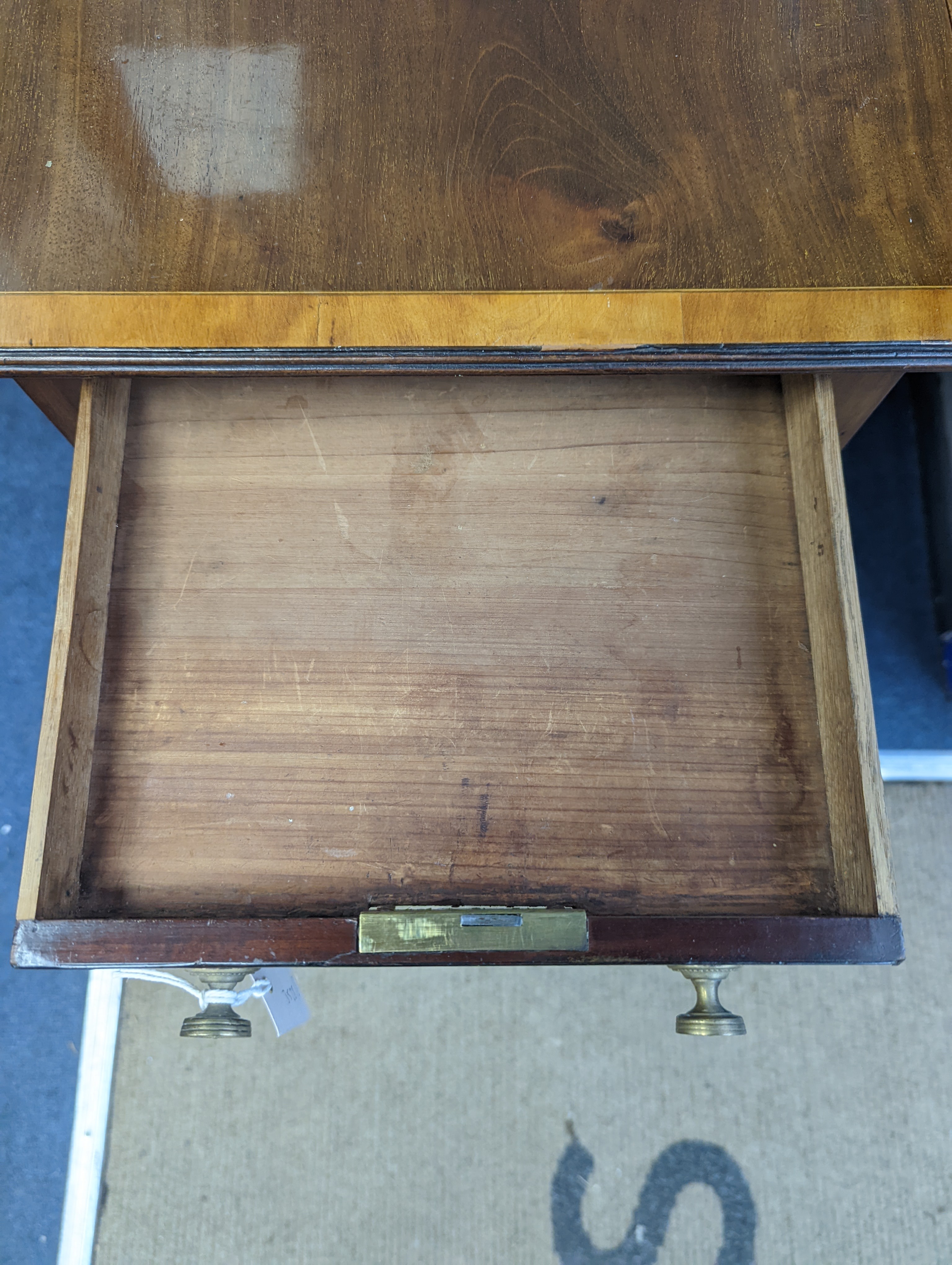 A Regency satinwood banded mahogany drop flap work table, width 69cm extended, depth 46cm, height 76cm